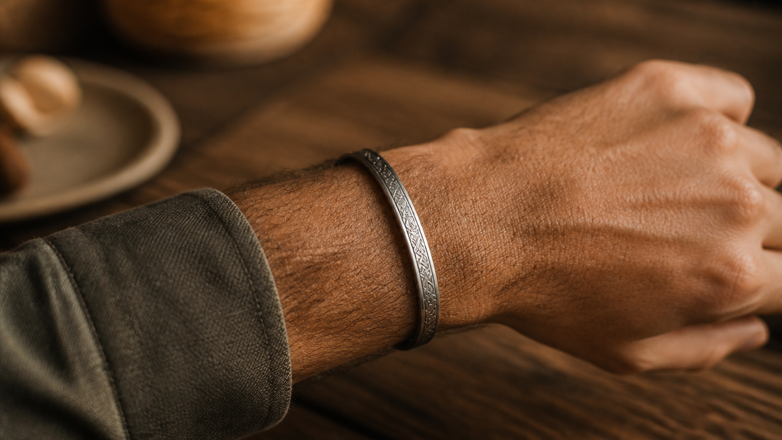 Close-up of a man wearing a stylish engraved bracelet on his wrist, symbolizing deep connection.