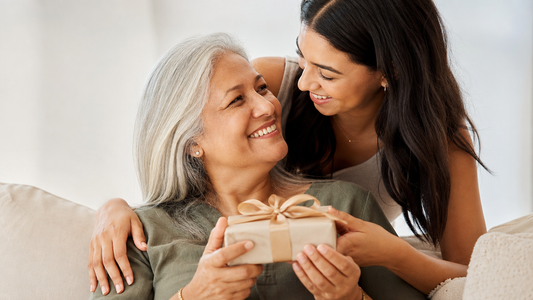 Mother opening a sentimental gift from her child, symbolizing love and connection