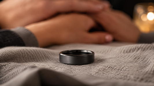 A modern men's proposal ring, a symbol of commitment, resting on a soft fabric with a warm, inviting glow.