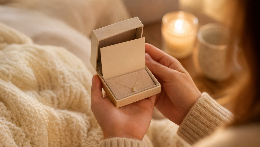 Hand holding sentimental jewelry with a message card, symbolizing comfort and support for a loved one.