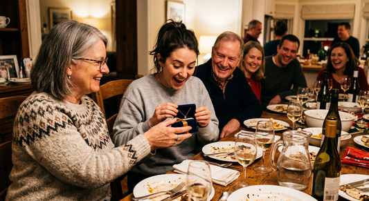 Mother in law giving jewelry gift to daughter in law at family dinner