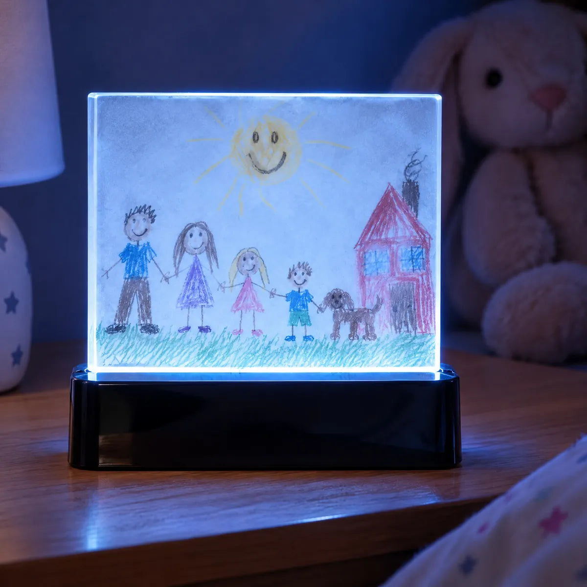 A cheap acrylic light: plain block, faded print, black plastic base, cold blue light